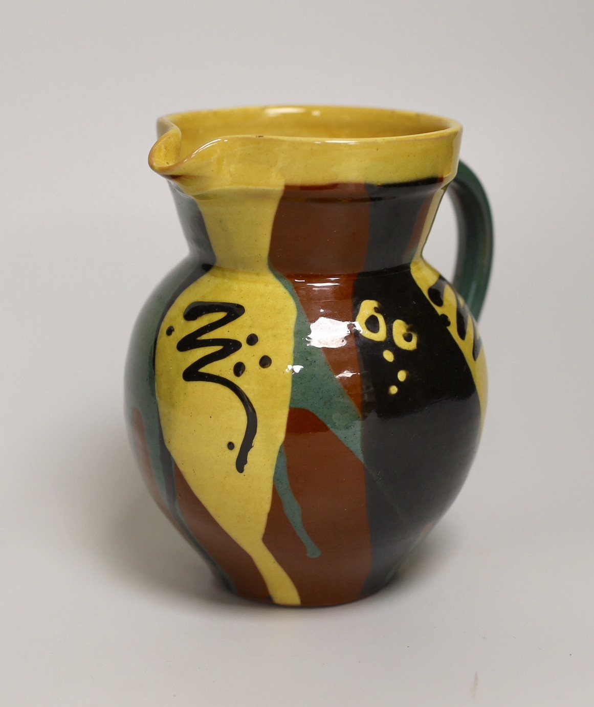 Margaret Brompton studio pottery bowl with insects, together with a slipware jug, a Longpark, Torquay small cockerel jug, and a Susan Juniper slipware jug, largest 21cm diameter, (4)